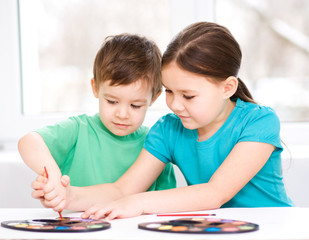 Children are painting with paint