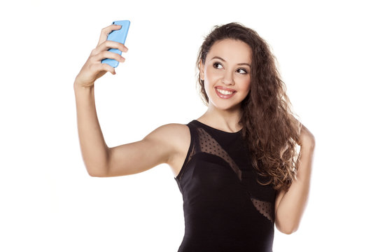pretty teen girl taking selfies with her smart phone