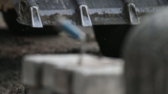 Digger shovels sand, roadworks