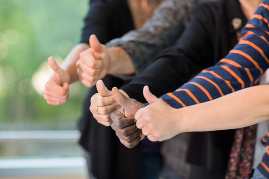 Multiethnic University Students Gesturing Thumbsup