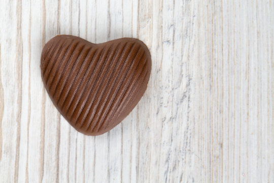 heart chocolate on white wooden surface