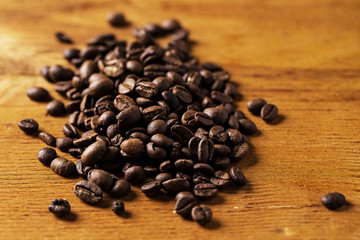Coffee beans over wooden surface