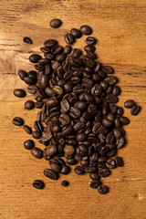 Coffee beans over wooden surface