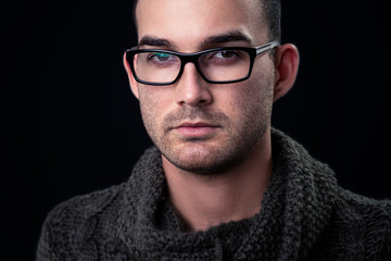 fashion portrait of the young beautiful man - dark background