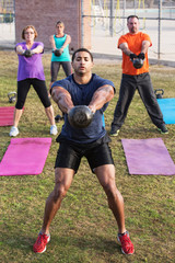 Strong Man Leading Kettle Bell Training