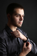 Handsome young man on dark background