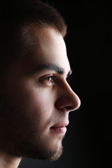 Fototapeta premium Handsome young man on dark background