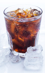 Glass of cold cola soda drink with ice cubes