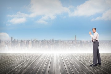 Composite image of thinking businessman holding pen