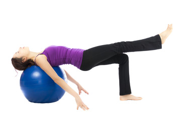Young woman doing pilates ball exercises