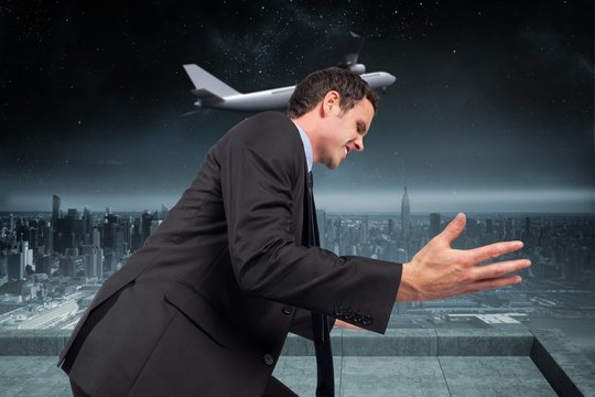 Composite image of businessman posing with arms out