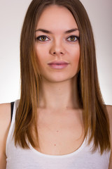 Fototapeta premium Portrait of a beautiful young woman in a white T-shirt