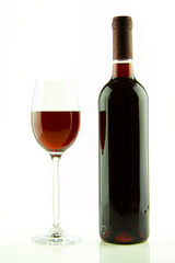 Bottle and glass of red wine isolated