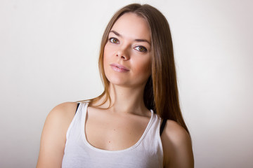Portrait of a beautiful young woman in a white T-shirt