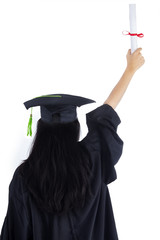 Woman in graduation gown celebrating success