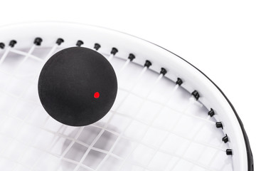 Close up of a squash racket and ball over white