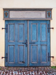 Old blue antique wooden door with padlock.