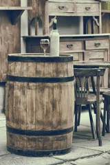 Foto op Aluminium Vintage stylized photo of wooden barrel with bottles of wine and © chamillew