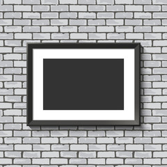 Black frame on brick wall.