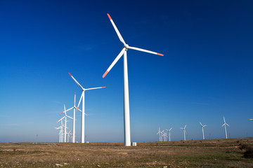 Fototapeta premium Wind power generators with blue clear sky