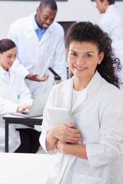 Portrait Of Technician In Laboratory With Colleagues