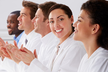 Portrait Of Technician And Colleagues In Laboratory Clapping
