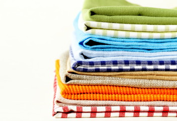 stack of colorful kitchen napkins on white background