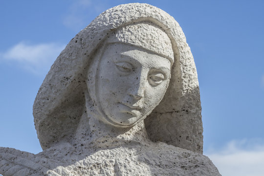 sculpture of a woman praying.Cerro de los Angeles is located in