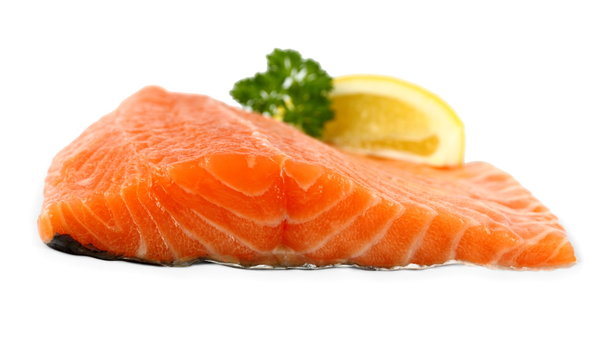 Raw, red salmon fillet with lemon wedge, frontal