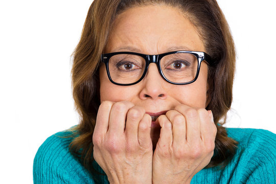 Old anxious nerdy woman biting her fingernails