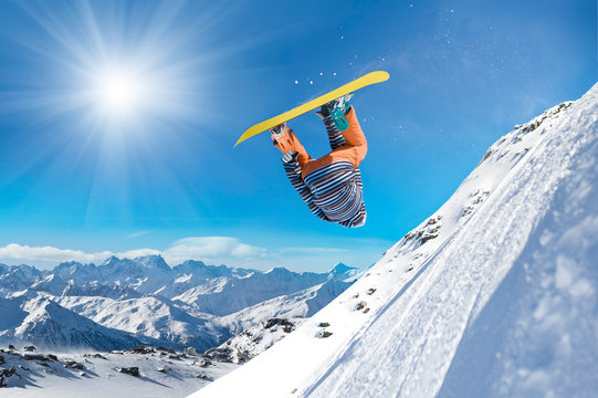 Extreme snowboarder jumping high in the air