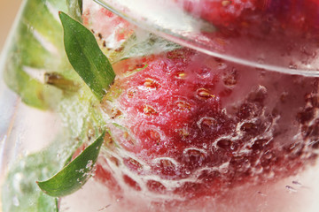 strawberry splashing into cocktail drink