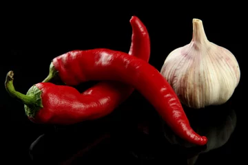 Gardinen Chilischoten Red hot chili peppers and garlic, isolated on   black  © Africa Studio