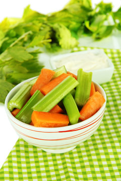 Fresh green celery with vegetables in bowl on table close-up