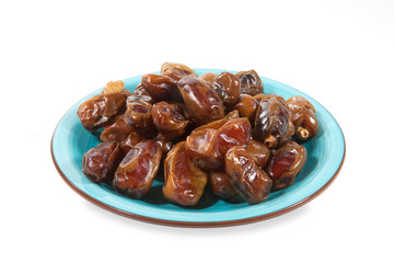 Dried dates in blue cup isolated on white
