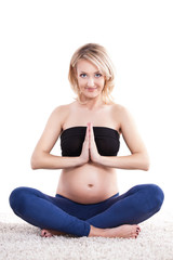 pregnant woman performing a yoga routine to relax over white