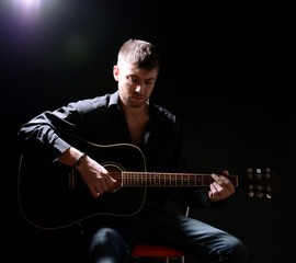 Young musician playing acoustic guitar and singing,