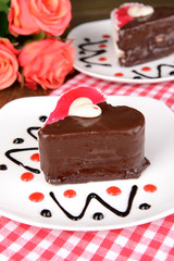 Sweet cakes with chocolate on plate on table close-up