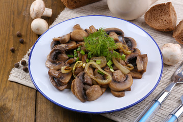 Delicious fried mushrooms on plate on table close-up