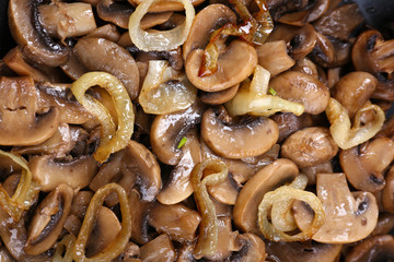Delicious fried mushrooms in pan close-up