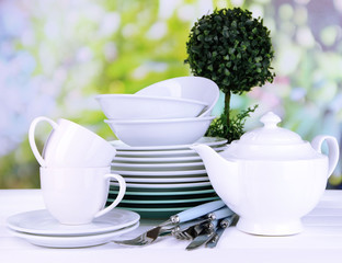 Clean dishes on table on natural background