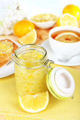Tasty lemon jam on table close-up