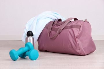 Sports bag with sports equipment in gymnasium