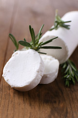 Tasty bushe cheese with rosemary, on wooden table © Africa Studio