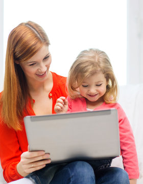 happy mother and daughter with laptop computer