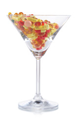 Goblet with pills isolated on white