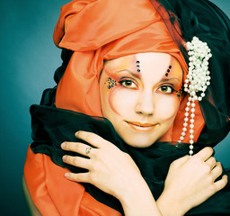 Young woman in black and orange turban