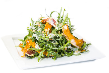 salad of arugula figs and cheese on white background