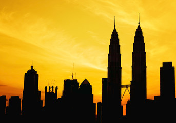 Naklejka premium Silhouette of KLCC tower during golden sunrise