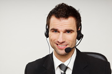 Handsome operator speaks into microphone